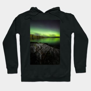 Northern lights glowing over lake in Finland Hoodie